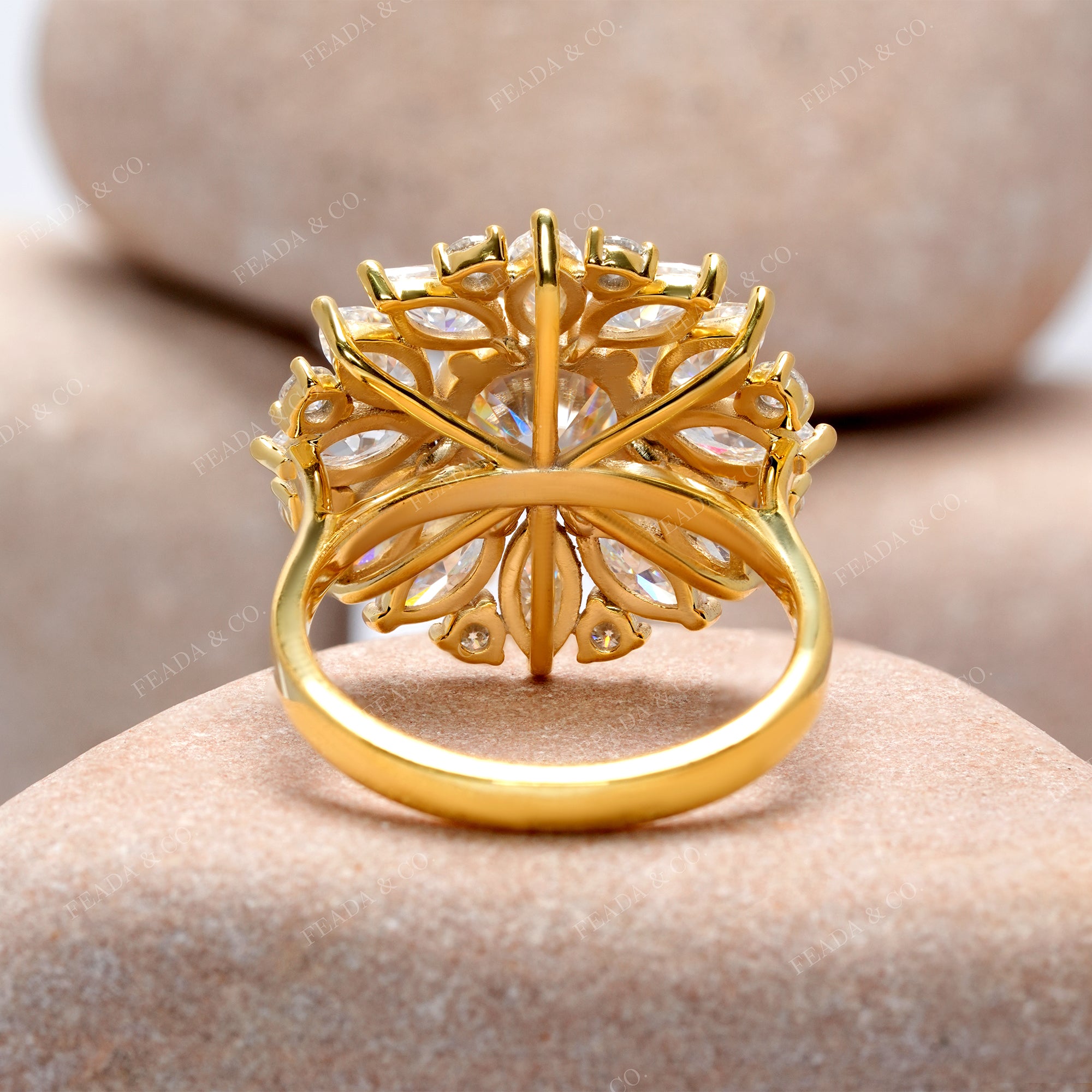 Gold ring with intricate design on a stone surface