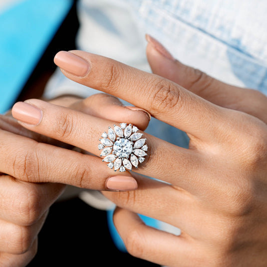 Close-up of a hand wearing a sparkling diamond ring with a blurred background